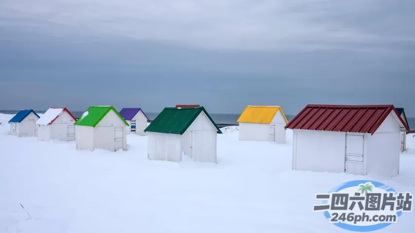 雪地里有许多白色的小房子，屋顶五颜六色