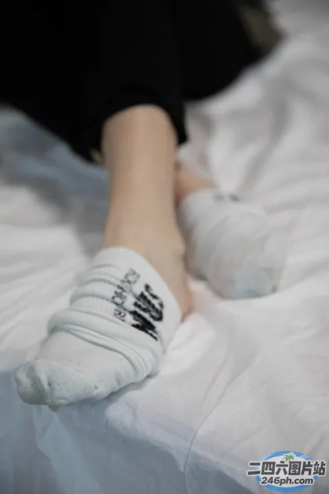 有人躺在床上，双脚抬起