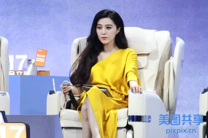 坐在椅子上，手里拿着手机的女人
