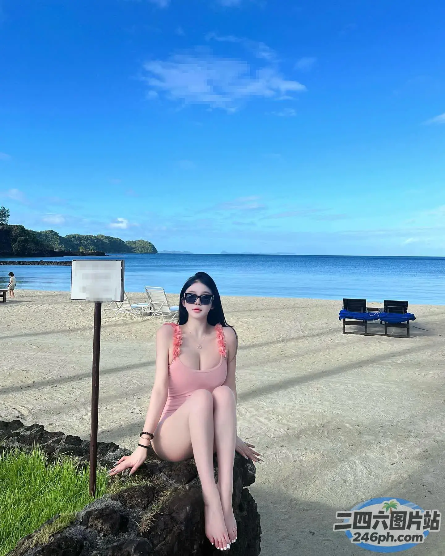 海滩上坐着一根木头上的女人