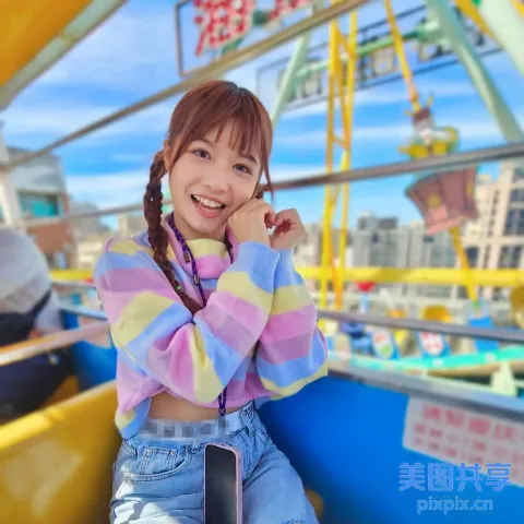Araffe Girl 坐在嘉年华游乐设施上，脸上带着微笑