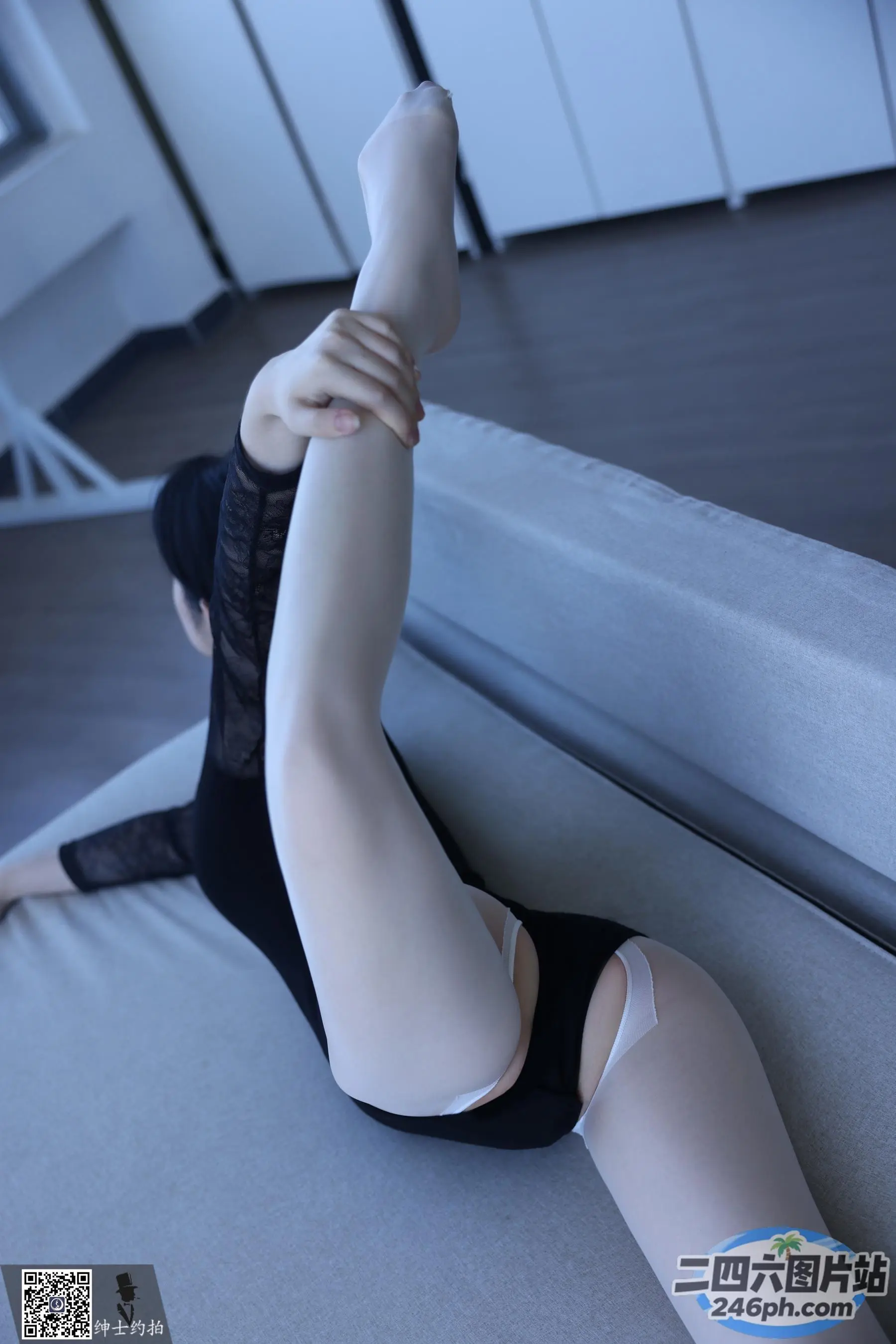 有一个女人穿着黑色的 Leoper 上衣和白色的紧身衣