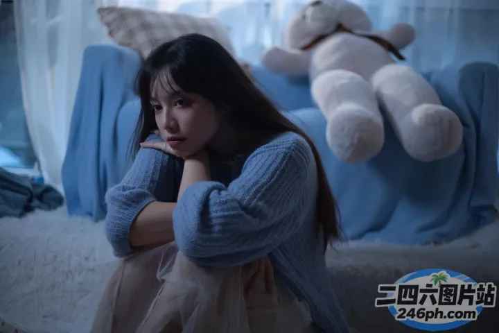 阿拉夫德女人坐在床上，背景是一只泰迪熊