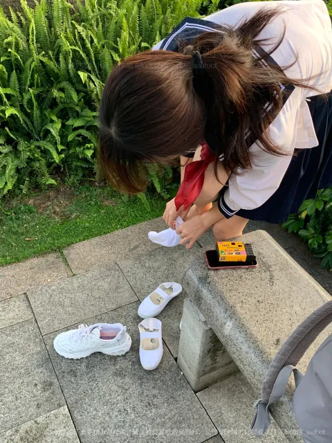 阿拉菲女子在长凳上看着一双鞋