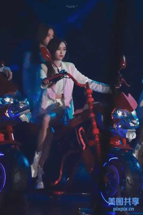 有一个女人骑着摩托车，车上骑着一个男人