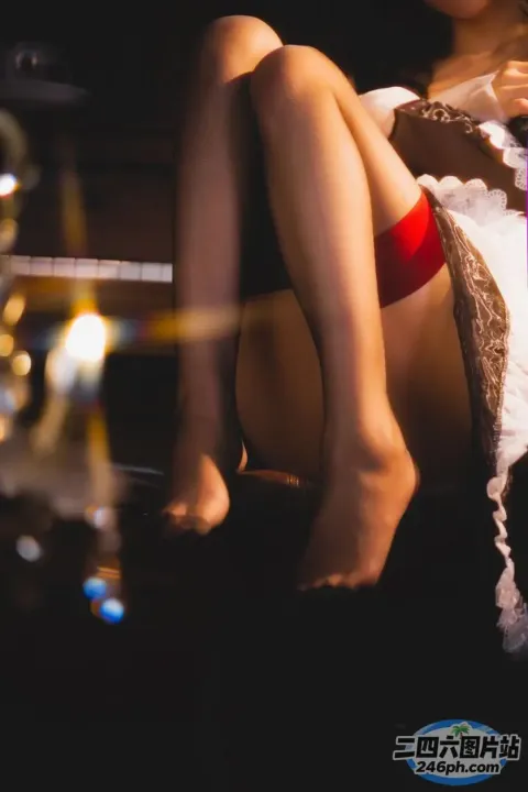 有个女人坐在沙发上，手里拿着一杯酒