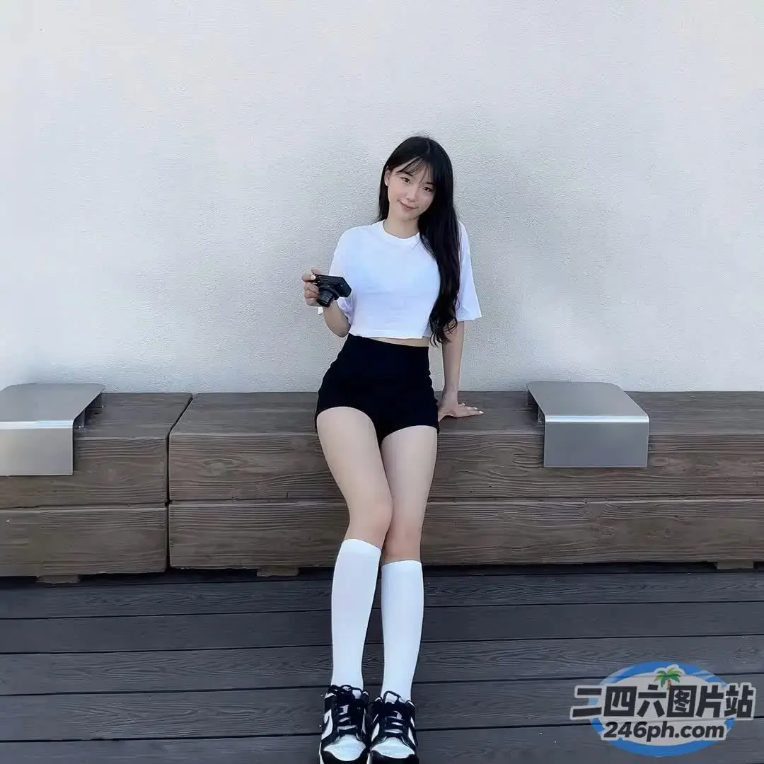 一位女士坐在长凳上，手里拿着一杯咖啡