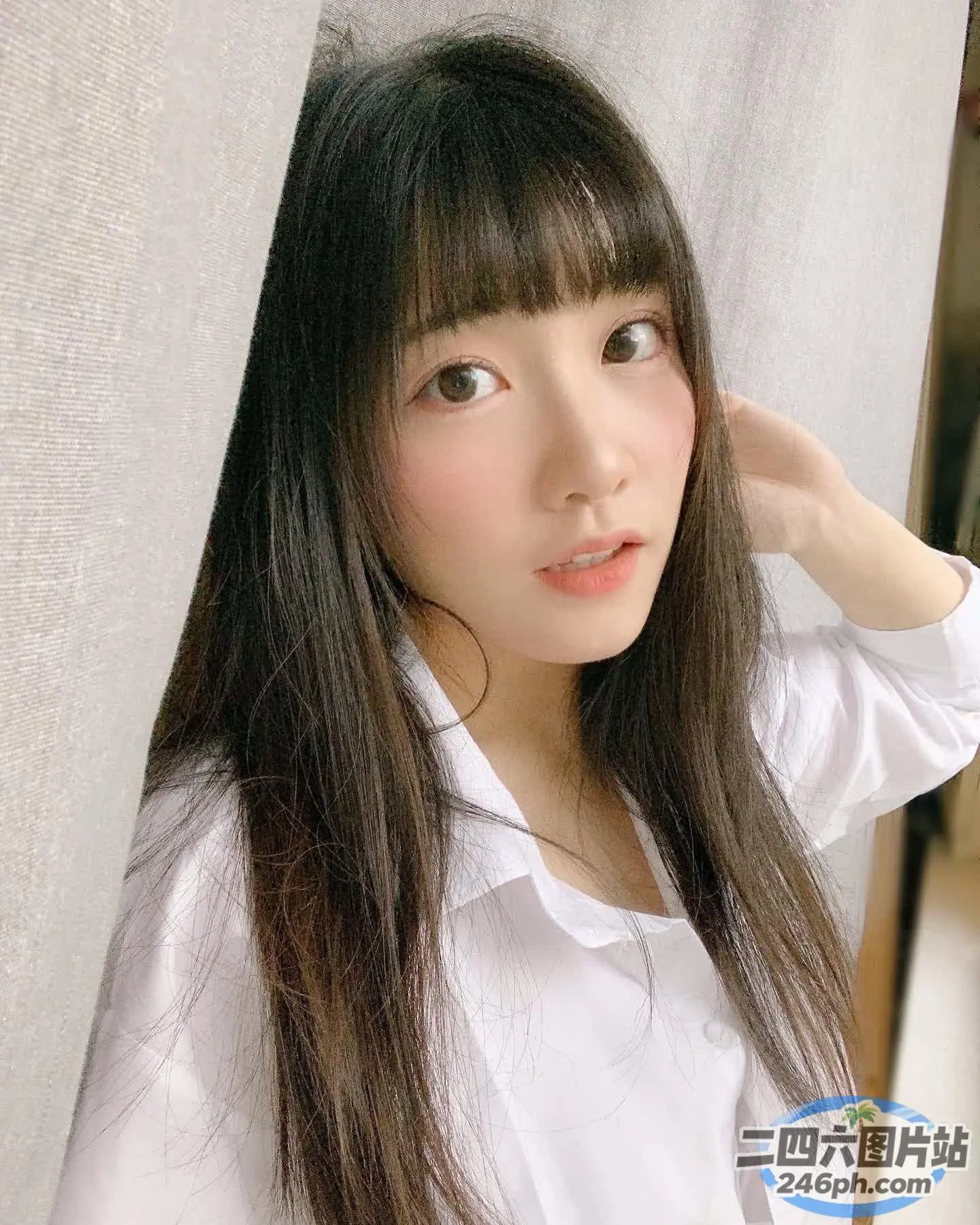 一位穿着白衬衫的长发女人的特写