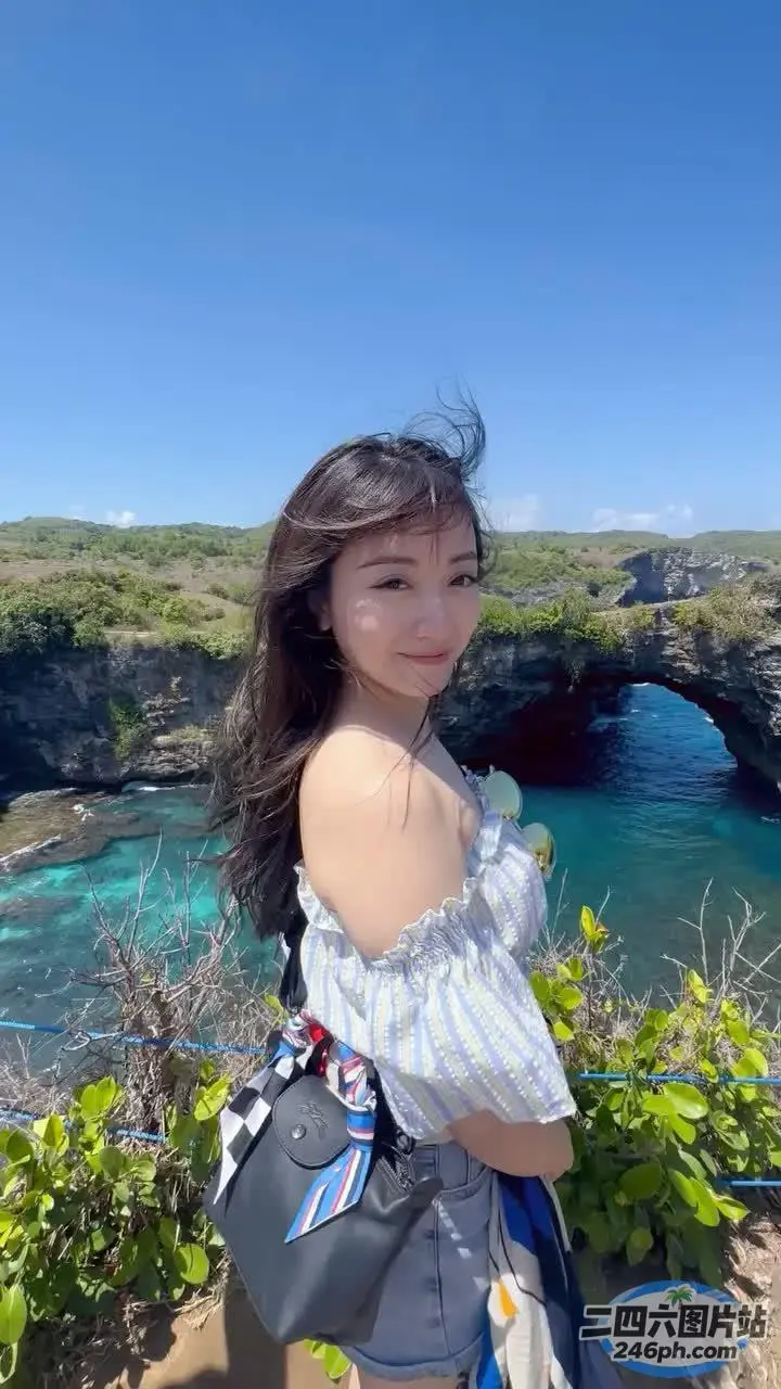 一个女人站在悬崖上俯瞰着一片水面