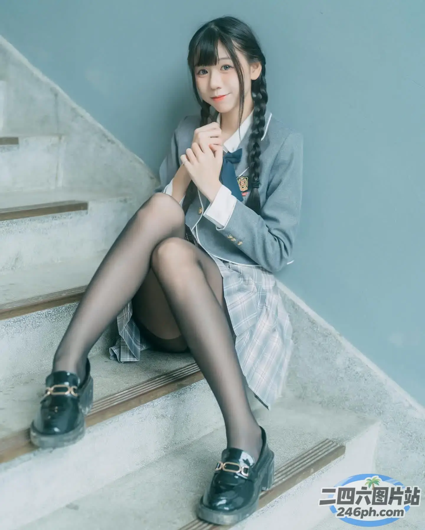 楼梯上坐着一个双腿交叉的女人