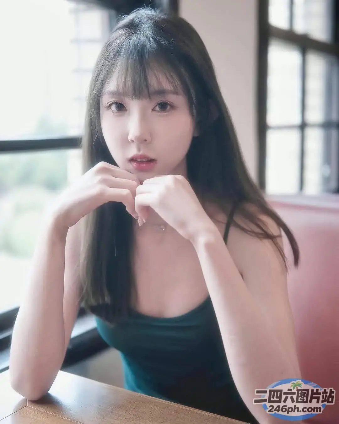 一个女人坐在桌子旁喝咖啡的特写
