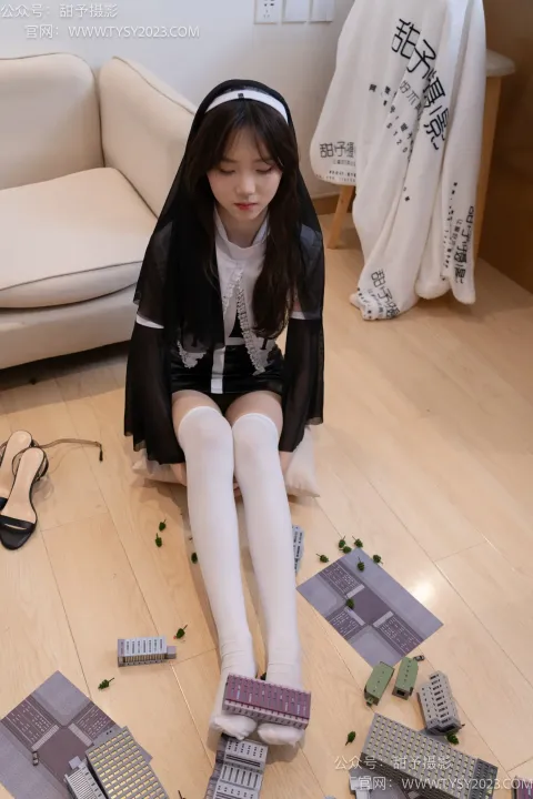 阿拉菲德女孩坐在地板上，手里拿着一堆药丸