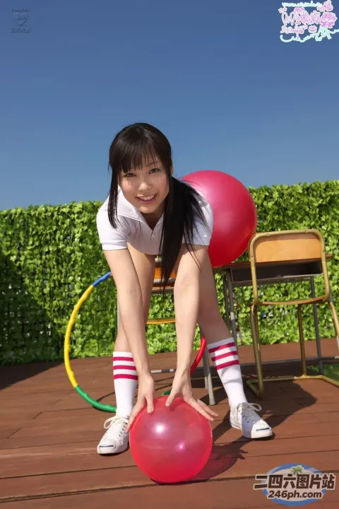 穿着白衬衫和白袜子的亚洲女孩玩红球