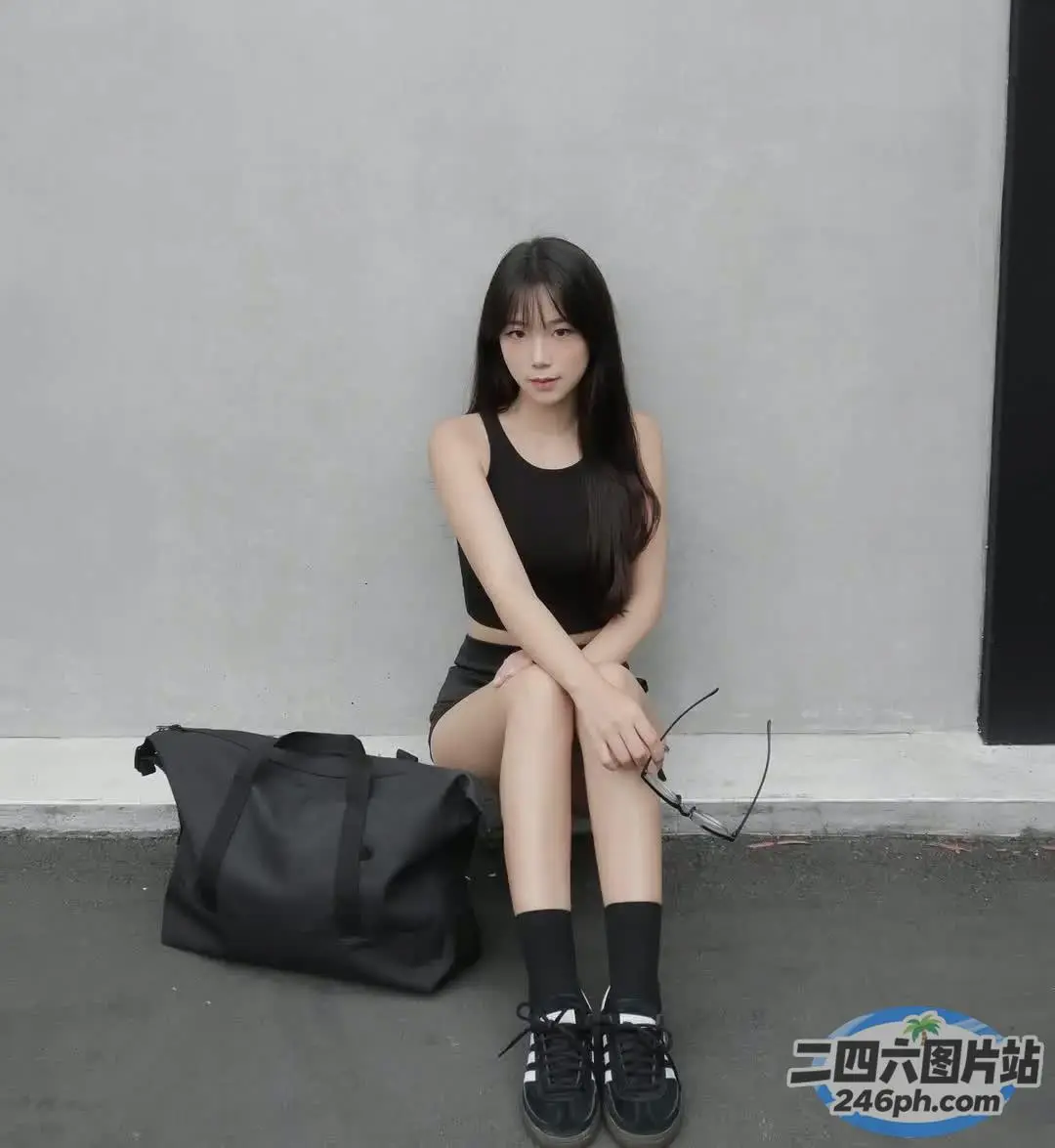 拿着包和背包坐在地上的阿拉菲女孩