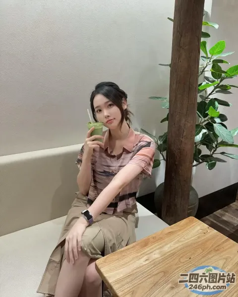 有一个女人坐在长凳上，手里拿着一杯酒