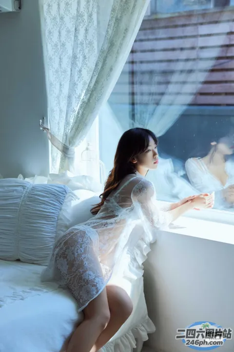 有一个女人坐在床上望向窗外